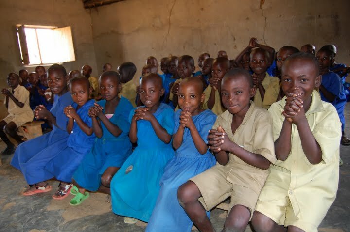 Rwandan schoolchildren excited to receive their deworming medication. Photo courtesy of The Access Project