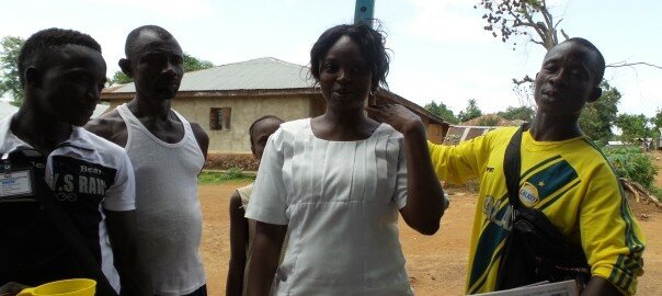 Measuring the District Health Sister of Kenema, Sierra Leone to determine the appropriate dosage of NTD medicine for her. Photo: FHI360